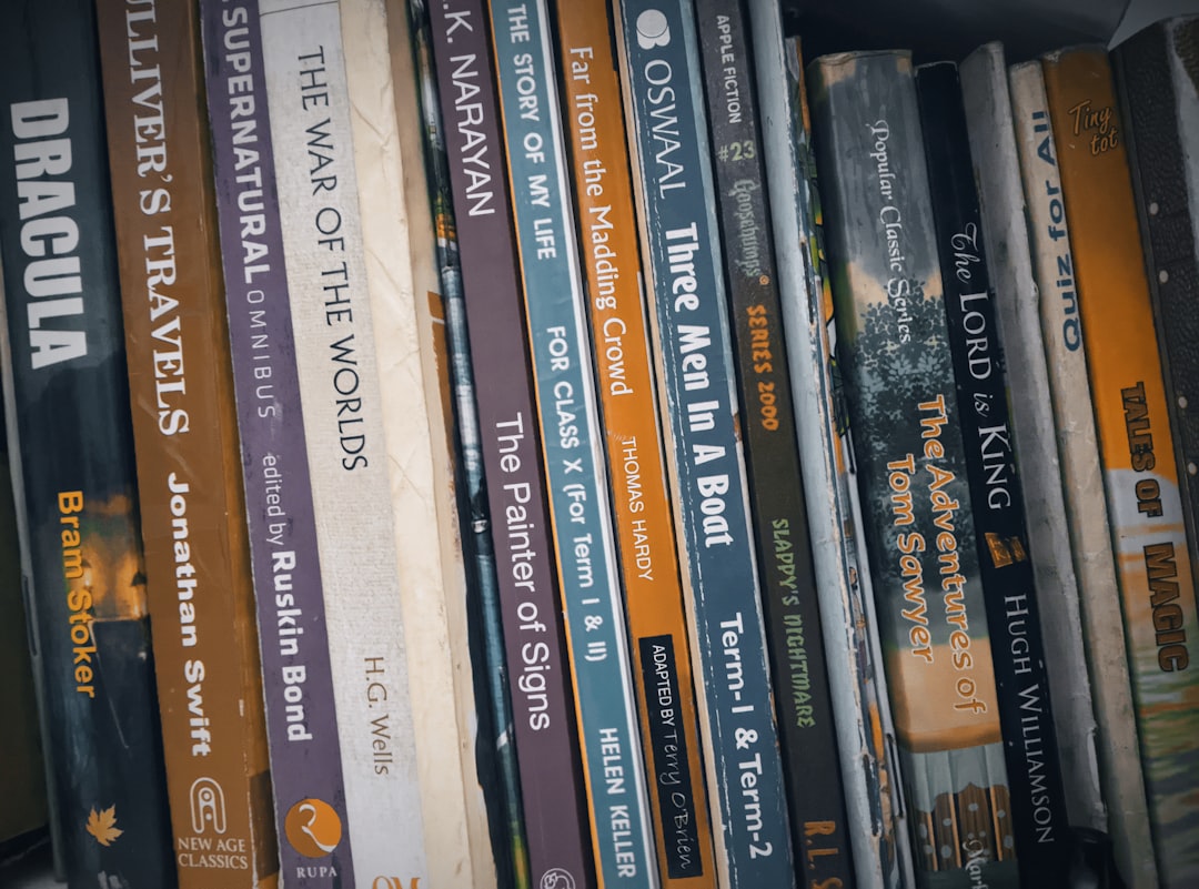 a row of books sitting on top of a shelf