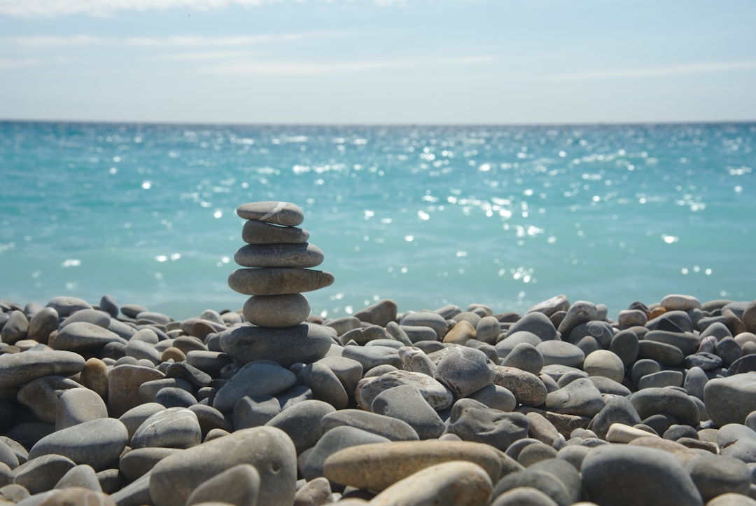 a pile of rocks sitting on top of a beach