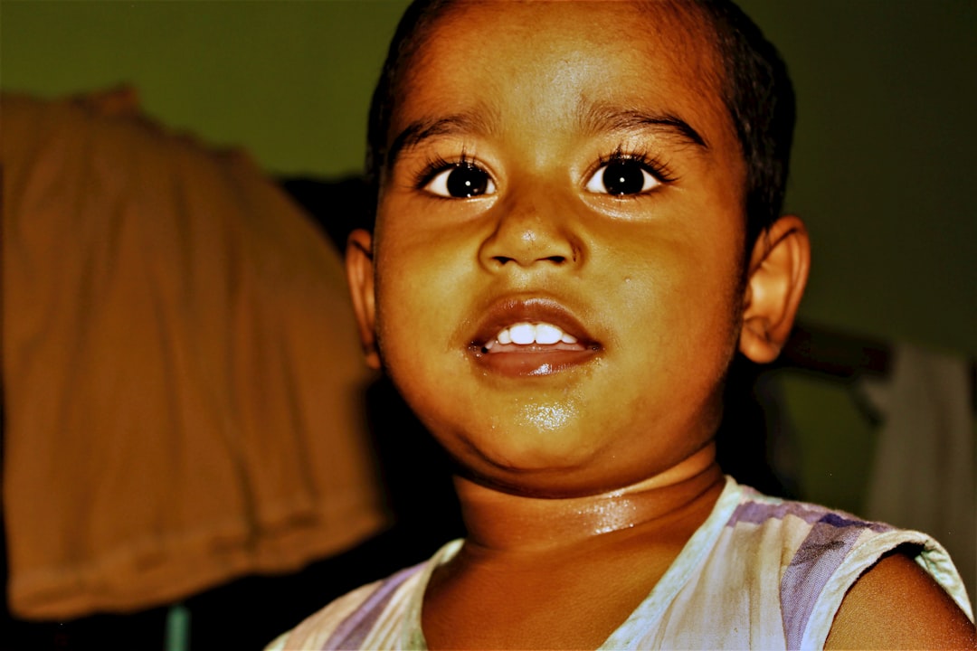 Young boy with wide eyes looking forward