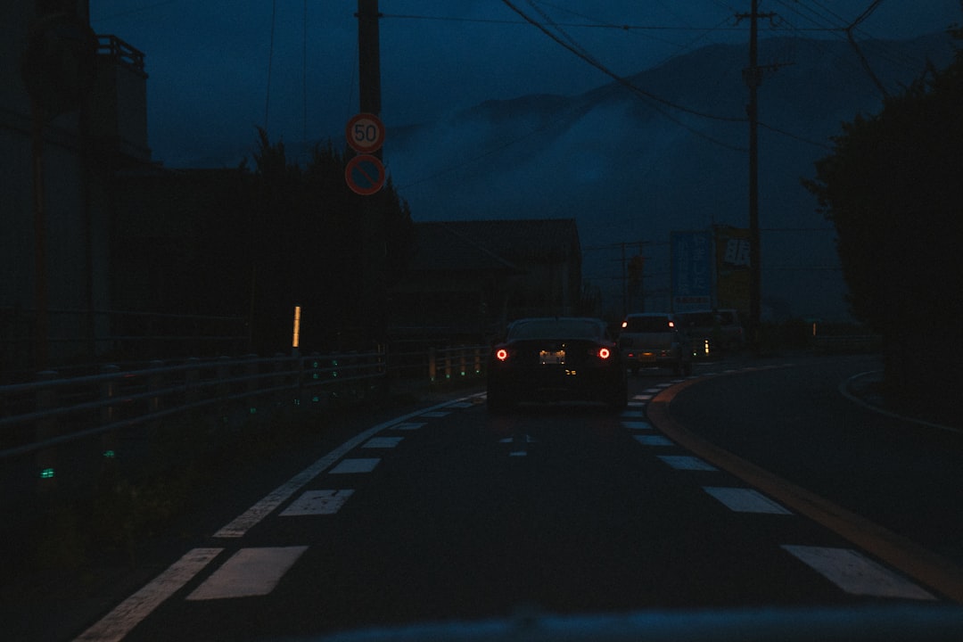 a car driving down a street at night