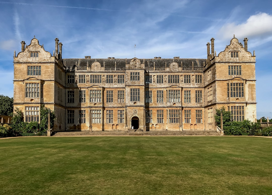 a large building sitting on top of a lush green field