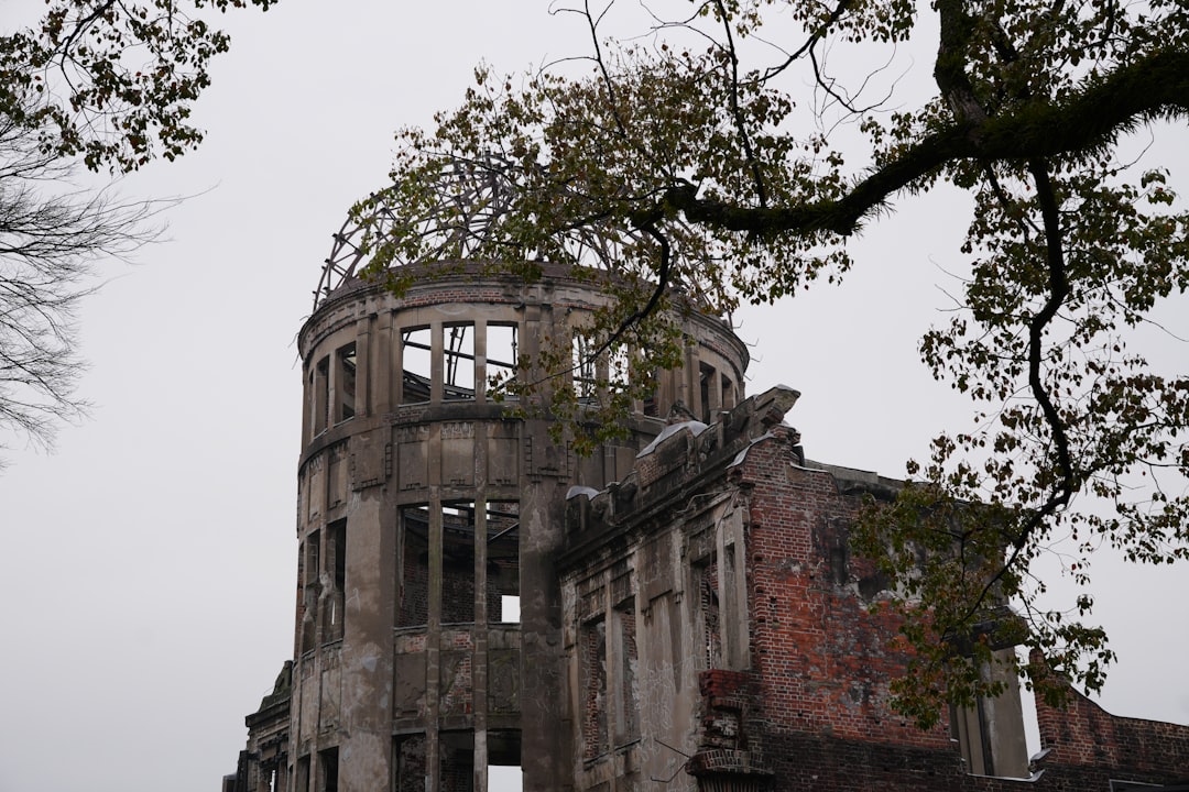 an old building with a tree in front of it